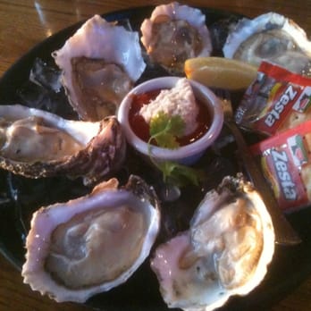 Jonah’s Seafood House signature dishes "The Whale" (Jumbo Breaded Pork Tenderloin), Oysters on the Half Shell, Fresh Grouper, Crab Cakes